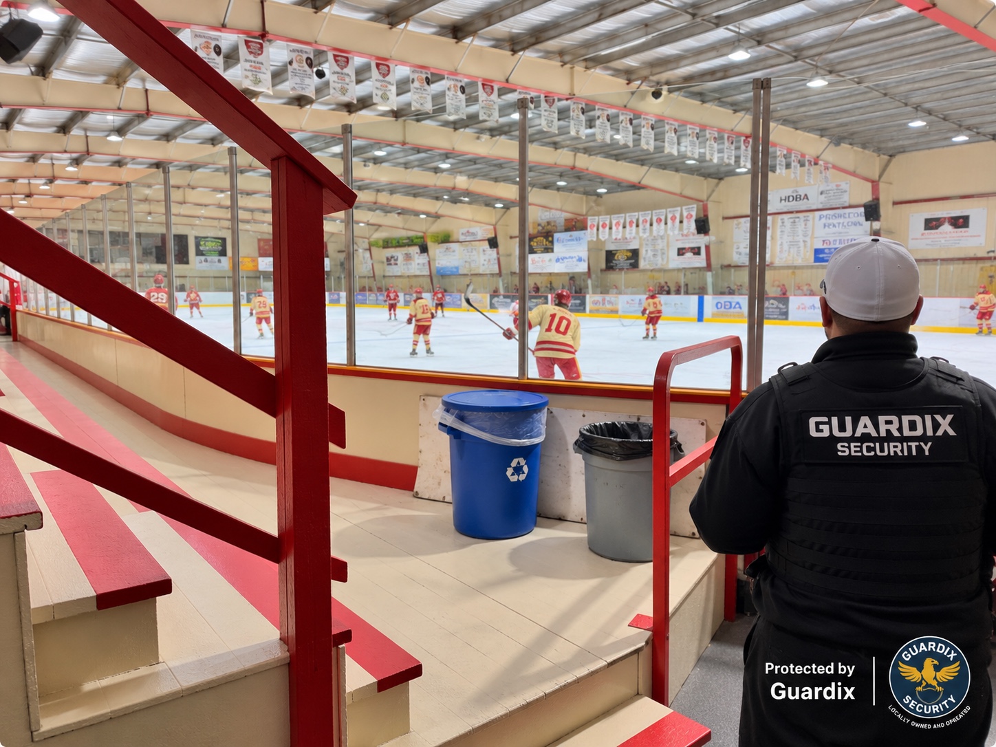 Guardix Security officer watching over spectators and the rink at a local ice hockey event